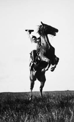 ERWIN E. SMITH (1886-1947). American cowboy photographer. Photographed riding a bucking bronco on the open range of Texas, 19 June 1909.  Copyright: xGRANGERx xGRANGERx 0002590
