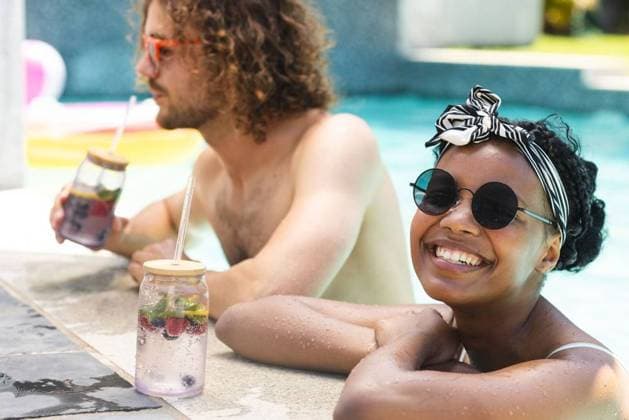 Diverse couple, a young African American woman and Caucasian man, relax by a pool, enjoying drinks Diverse couple, a young African American woman and Caucasian man, relax by a pool, enjoying drinks. She wears round sunglasses and a headscarf, while he sports curly hair and tinted glasses., model released, , property released, Cape Town, South Africa, 15.11.2023, 4961044.jpg, people,diverse couple,young African American woman,Caucasian man,pool,drinks,round sunglasses,headscarf,curly hair,tinted glasses,relaxation,leisure,fun,lifestyle,happy,relationship,love,summertime,outdoor,enjoyment,vacation,interracial,mixed race,diversity,cocktail,refreshment,chilling,lounging,leisure activity,poolside,holiday,romantic,bonding,sunbathing,swimwear,fas