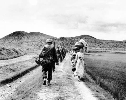 RECORD DATE NOT STATED Korea: During the Korean War (1950-1953), a line of US Army soldiers file past a group of Korean women and children carrying their possessions. The Korean War (25 June 1950 - armistice signed 27 July 1953) was a military conflict between the Republic of Korea, supported by the United Nations, and North Korea, supported by the People s Republic of China (PRC), with military material aid from the Soviet Union. The war was a result of the physical division of Korea by an agreement of the victorious Allies at the conclusion of the Pacific War at the end of World War II.<br ><br > The Korean peninsula was ruled by Japan from 1910 until the end of World War II. Following the surrender of Japan in 1945, American administrators divided the peninsu Copyright: xxPicturesxFromxHistoryx