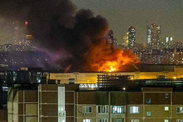 RUSSIA, MOSCOW REGION - MARCH 22, 2024: Smoke rises over the Crocus City Hall in the town of Krasnogorsk where unidentified persons opened fire. Evacuation is underway. Roman Denisov TASS  68456786