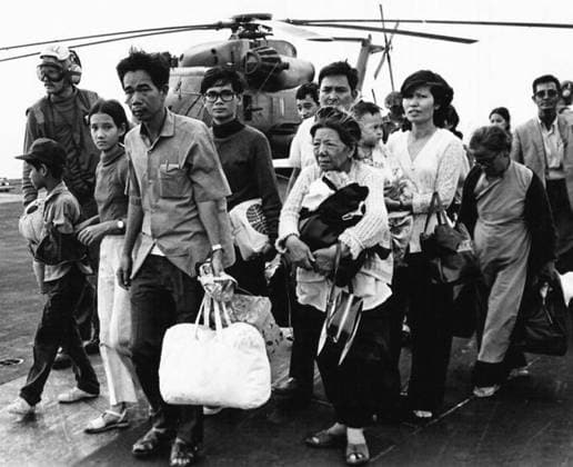 Vietnam: South Vietnamese refugees fleeing the communist conquest of Saigon in 1975 arrive at Camp Foster, Okinawa, Japan. CAMP FOSTER, OKINAWA, Japan ãƒ»South Vietnamese refugees walk across a U.S. Navy vessel. Operation Frequent Wind, the final operation in Saigon, began April 29, 1975. During a nearly constant barrage of explosions, the Marines loaded American and Vietnamese civilians, who feared for their lives, onto helicopters that brought them to waiting aircraft carriers. The Navy vessels brought them to the Philippines and eventually to Camp Pendleton, Calif. (Official U.S. Navy photo in Public Domain). Copyright: xxPicturesxFromxHistoryx