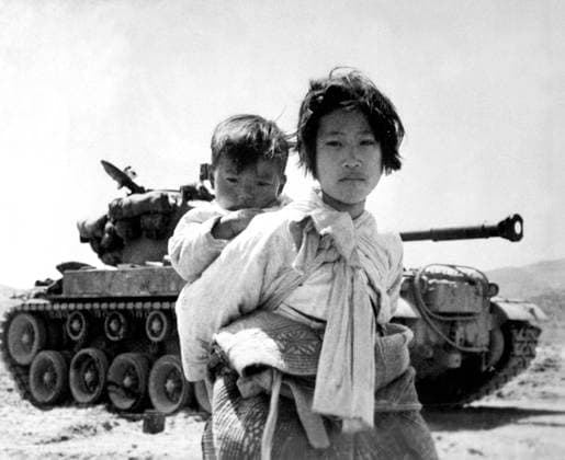 Korea: With her brother on her back a war-weary Korean girl trudges by a M-26 tank at Haengju. Korean War (1950-1953). The Korean War (25 June 1950 - armistice signed 27 July 1953) was a military conflict between the Republic of Korea, supported by the United Nations, and North Korea, supported by the People s Republic of China (PRC), with military material aid from the Soviet Union. The war was a result of the physical division of Korea by an agreement of the victorious Allies at the conclusion of the Pacific War at the end of World War II.<br ><br > The Korean peninsula was ruled by Japan from 1910 until the end of World War II. Following the surrender of Japan in 1945, American administrators divided the peninsula along the 38th Parall Copyright: xxPicturesxFromxHistoryx
