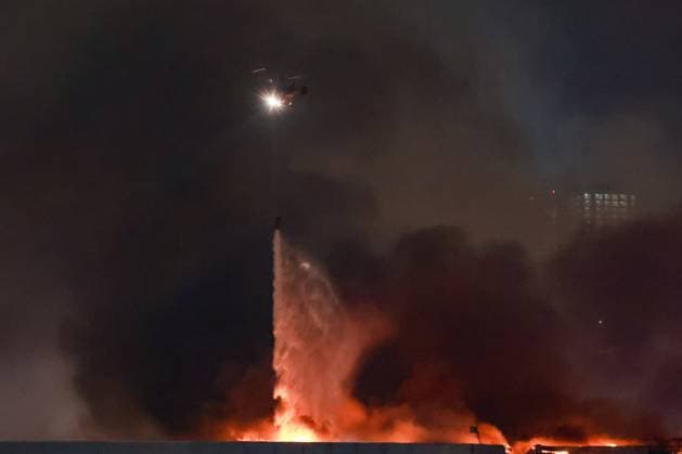 RUSSIA, MOSCOW REGION - MARCH 22, 2024: A helicopter battles a fire at the Crocus City Hall in the town of Krasnogorsk after a mass shooting by several unidentified gunmen. Evacuation is underway. Vyacheslav Prokofyev TASS  68459872