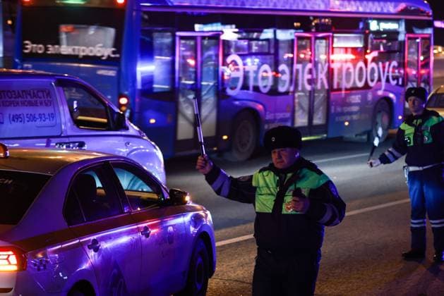 RUSSIA, MOSCOW REGION - MARCH 22, 2024: Traffic policemen inspect vehicles near the Crocus City Hall in the town of Krasnogorsk after a mass shooting by several unidentified gunmen. Evacuation is underway. Vladimir Gerdo TASS  68459647
