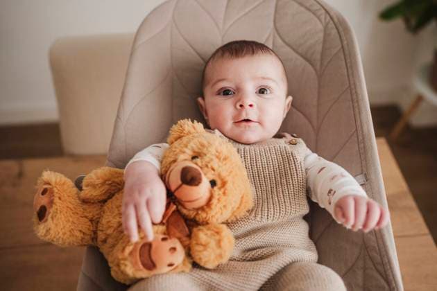 Creative Highlights Symbolbilder Cute baby girl sitting with stuffed toy on bouncer chair model released, Symbolfoto property released, EBBF08787