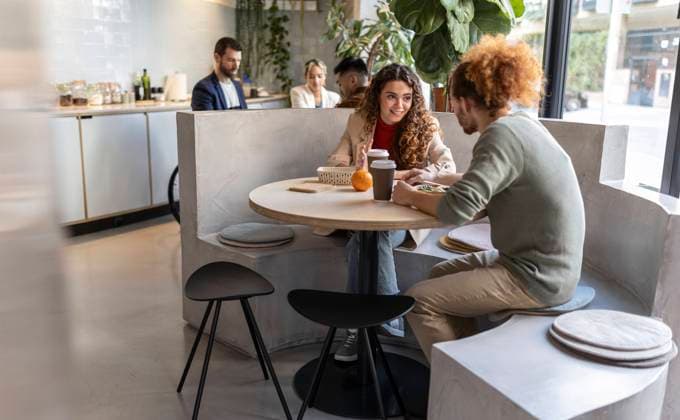 Business colleagues having lunch sitting on seat at office cafe model released, Symbolfoto property released, JCCMF11306