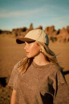 Creative Highlights Symbolbilder Thoughtful young woman wearing cap and standing on sunny day model released, Symbolfoto, ACPF01565