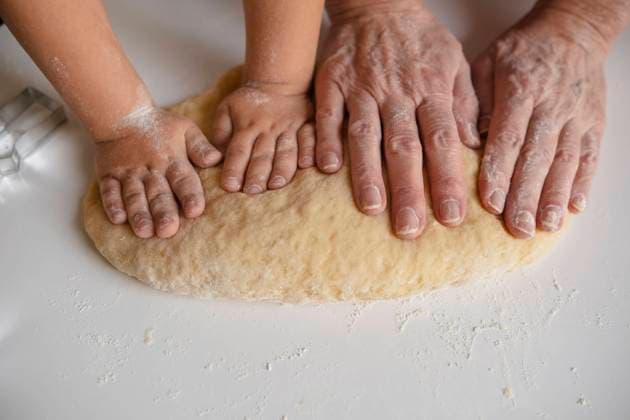 Creative Highlights Symbolbilder Hands of grandmother and grandson kneading dough at home model released, Symbolfoto, KVBF00012