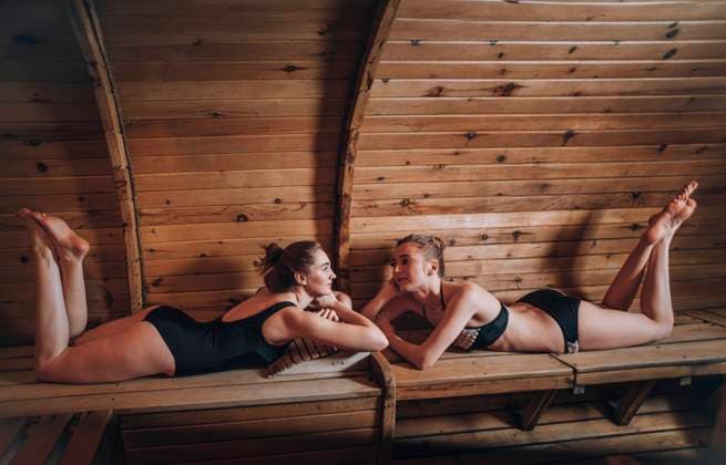 Friends relaxing on bench at sauna model released, Symbolfoto property released, ADF00290