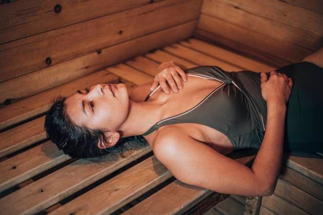 Young woman lying on bench at sauna model released, Symbolfoto property released, ADF00291