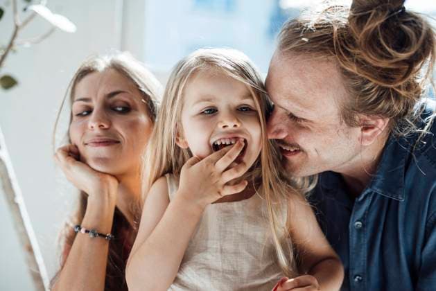Smiling father embracing daughter near mother at home model released, Symbolfoto property released, JOSEF23742