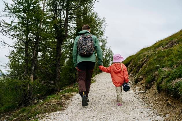 Father and daughter holding hands hiking on mountain model released, Symbolfoto, NSTF00029