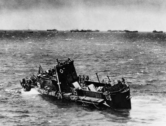 WORLD WAR II: D-DAY, 1944. U.S. Coast Guard landing craft sinks off the coast of Normandy after German shelling, 6 June 1944.  Copyright: xGRANGERx xGRANGERx 0099937