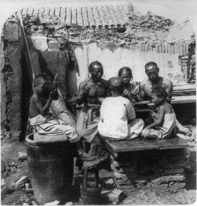 CHINA: FAMILY, c1900. A Chinese family eating a meal at their home in Tientsin, China, which was partially destroyed in 1900 during the siege of the Boxer Rebellion. Stereograph, c1900.  Copyright: xGRANGERx xGRANGERx 0115732