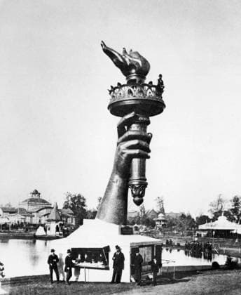 CENTENNIAL FAIR, 1876. The hand of the Statue of Liberty exhibited at the Centennial Exposition in Philadelphia, Pennsylvania, 1876. The sculptor, Frédéric Barthodi, poses alongside the flame.  Copyright: xGRANGERx xGRANGERx 0116647