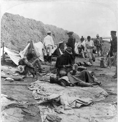 CHINA: BOXER REBELLION. An American soldier giving water to a wounded Japanese soldier after the Battle of Tientsin, China. Photograph, c1901.  Copyright: xGRANGERx xGRANGERx 0116701