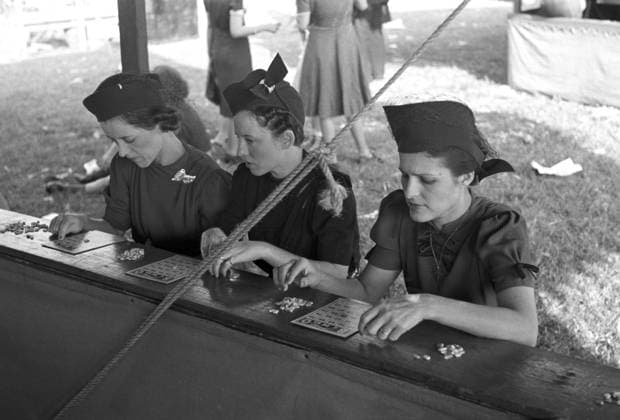 BINGO GAME, 1938. Three women playing bingo at the Louisiana State Fair in Donaldsonville, Louisiana. Photograph by Russell Lee, November 1938.  Copyright: xGRANGERx xGRANGERx 0121698