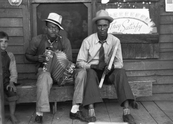 LOUISIANA: MUSICIANS, 1938. African American musicians playing the accordion and washboard in front of a store, near New Iberia, Louisiana. Photograph by Russell Lee, November 1938.  Copyright: xGRANGERx xGRANGERx 0122207