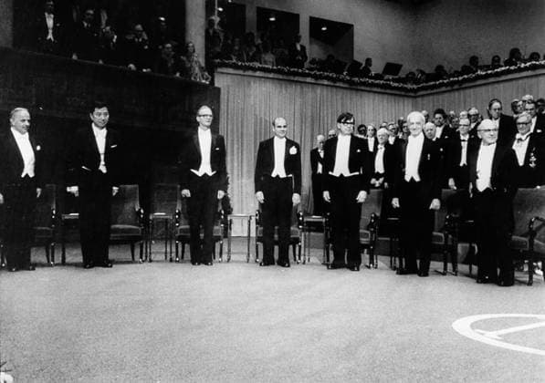 NOBEL PRIZE WINNNERS, 1976. The winners, all American, at the ceremony in the concert hall of Stockholm, Sweden. From left: Burton Richter (Physics); Samuel Ting (Physics); William Lipscomb (Chemistry); Baruch Blumberg (Medicine); Carleton Gajdusek (Medicine); Saul Bellow (Literature); and Milton Friedman (Economics).  Copyright: xGRANGERx xGRANGERx 0123882