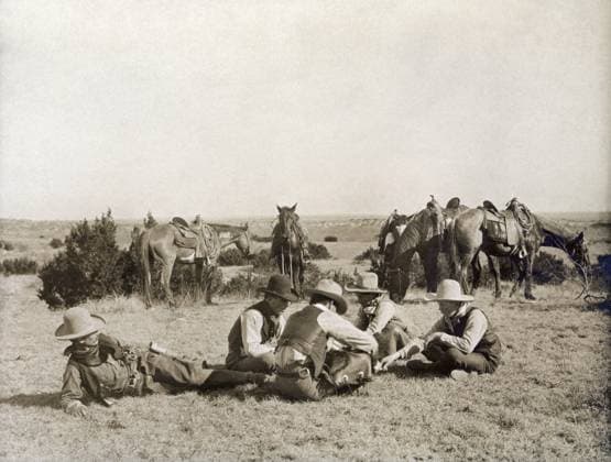 TEXAS: COWBOYS, c1906. Several cowboys seated on the ground while playing a game of mumblety peg during a work break at the Turkey Track Ranch in Texas. Photograph by Erwin Evans Smith, c1906.  Copyright: xGRANGERx xGRANGERx 0124927