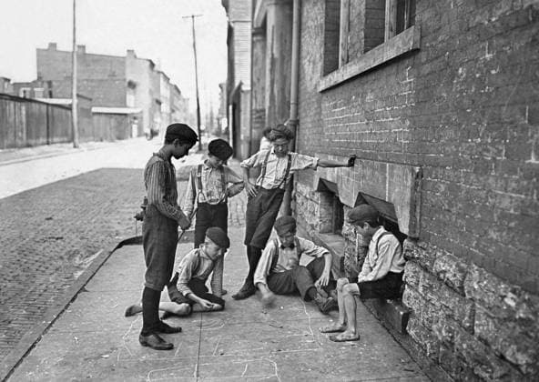 BOYS SHOOTING CRAPS, c1908. Group of boys gambling with dice on the sidewalk of Cincinnati, Ohio. Photograph by Lewis Hine, c1908.  Copyright: xGRANGERx xGRANGERx 0125812