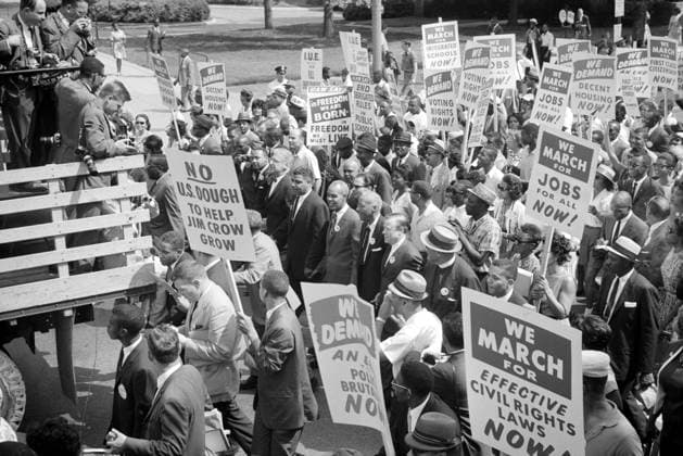 MARCH ON WASHINGTON, 1963. Martin Luther King, Jr., Roy Wilkins, and other civil rights leaders surrounded by crowds carrying signs at the March on Washington, 28 August 1963. Photographed by Warren K. Leffler.  Copyright: xGRANGERx xGRANGERx 0125836