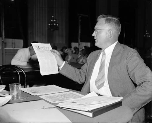 DIES COMMITTEE, 1938. Earl Martin, a Brooklyn professor, shows members of the House Un-American Activities Committee (HUAC), or the Dies Committee, communist propaganda distributed through the school under the guise of a school pamphlet. Photograph, 23 August 1938.  Copyright: xGRANGERx xGRANGERx 0128876