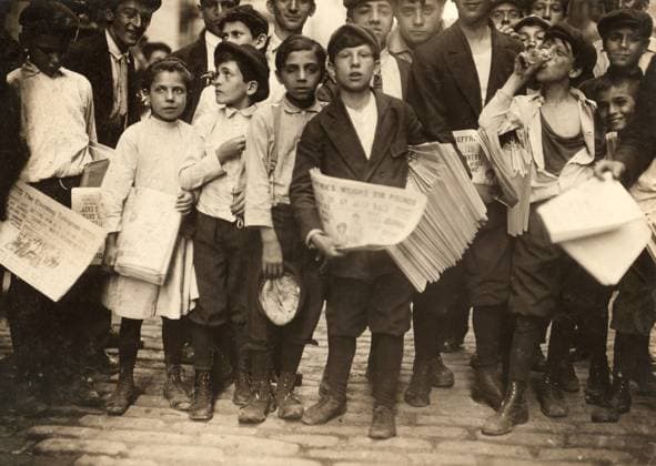 NEW YORK: NEWSBOYS, 1910. A group of newboys and one newsgirl getting the afternoon papers on Park Row, New York City. Photograph by Lewis Hine, July 1910.  Copyright: xGRANGERx xGRANGERx 0131729