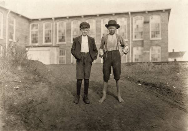 HINE: CHILD LABOR, 1908. Two young textile workers standing in front of the Wylie Mill in Chester, South Carolina. Photograph by Lewis Hine, November 1908.  Copyright: xGRANGERx xGRANGERx 0131960