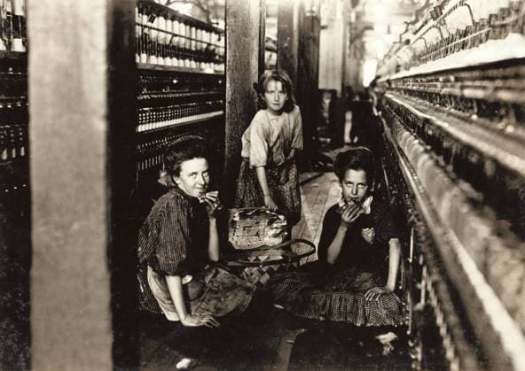 HINE: CHILD LABOR, 1908. Young workers eating their lunch on the floor between the spinning machines at the Kesler Mfg. Co. in Salisbury, North Carolina. Photograph by Lewis Hine, December 1908.  Copyright: xGRANGERx xGRANGERx 0132836