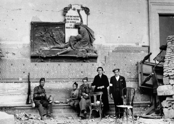 SPANISH CIVIL WAR, c1937. Two soldiers eat a meal with a family in a town after heavy fighting during the Spanish Civil War. Photograph by James Abbe, c1937.  Copyright: xGRANGERx xGRANGERx 0167098