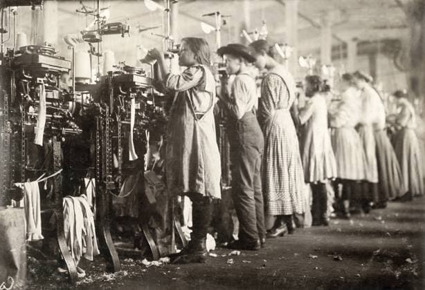 HINE: CHILD LABOR, 1910. A group of young knitters working at the textile machines at the Loudon Hosiery Mill in Loudon, Tennessee. Photograph by Lewis Hine, December 1910.  Copyright: xGRANGERx xGRANGERx 0167249