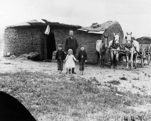 NEBRASKA: SETTLERS, 1887. Homesteader George Barnes and his children in front of their sod house in Custer County, Nebraska. Photograph by Solomon D. Butcher, 1887.  Copyright: xGRANGERx xGRANGERx 0176474