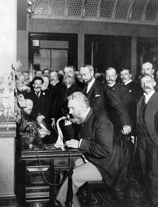 ALEXANDER GRAHAM BELL (1847-1922). American (Scottish-born) teacher and inventor. At the New York end of the first long-distance telephone call to Chicago. Photograph, 18 October 1892.  Copyright: xGRANGERx xGRANGERx 0180633