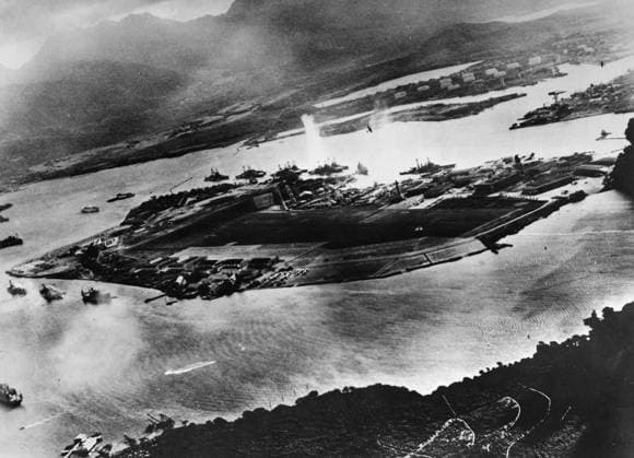 WWII: PEARL HARBOR, 1941. The commencement of the air attack against the United States naval base at Pearl Harbor, captured from a Japanese plane. The focus is Ford Island, surrounded by American warships; the explosion at center is a torpedo strike against the USS West Virginia. Photograph, 7 December 1941.  Copyright: xGRANGERx xGRANGERx 0183752