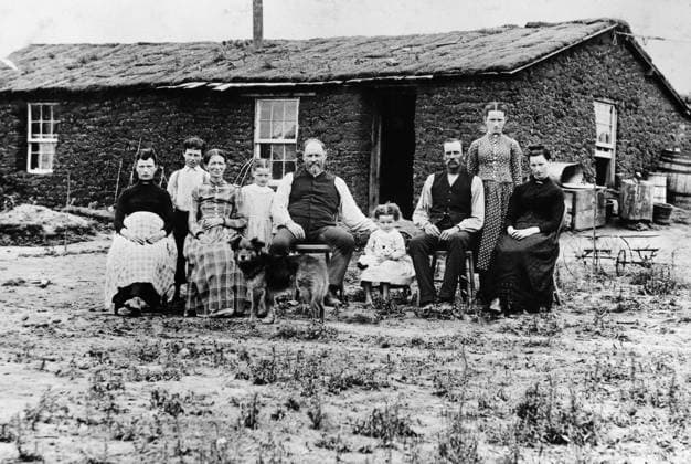 NEBRASKA: SETTLERS, c1890. A homesteader family in front of their sod house in Nebraska. Photograph by Solomon D. Butcher, c1890.  Copyright: xGRANGERx xGRANGERx 0186450