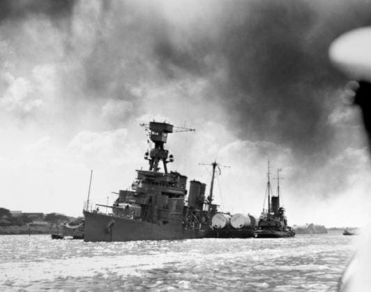 WWII: USS RALEIGH, 1941. The USS Raleigh being kept afloat by barges and tugboats after being damaged by the Japanese air raid on Pearl Harbor. Photograph, 7 December 1941.  Copyright: xGRANGERx xGRANGERx 0216881