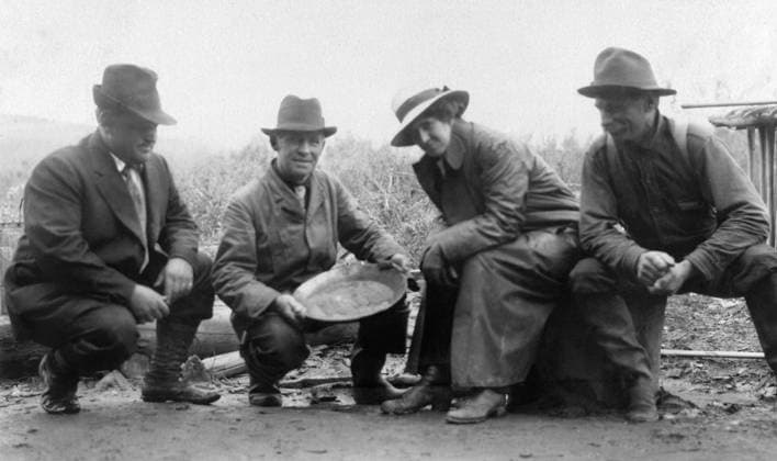 ALASKA: MINING, c1910. Men and women posing with a pan of gold in Chatanika, Alaska. Photograph, c1910.  Copyright: xGRANGERx xGRANGERx 0266509