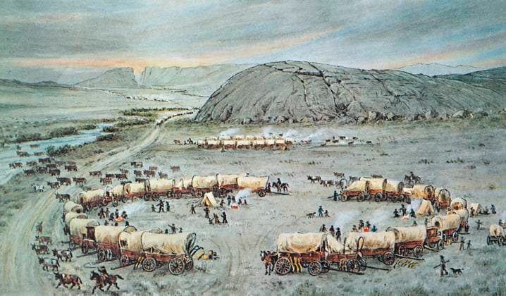 OREGON TRAIL: EMIGRANTS. An emigrant wagon train on the Oregon Trail encamped by the Sweetwater River near Independence Rock, Wyoming. Watercolor, c1929, by William Henry Jackson.  Copyright: xGRANGERx xGRANGERx 0267532