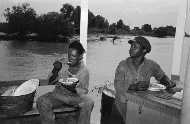 LOUISIANA: STEVEDORES, 1938. Stevedores eating on stern of the boat El Rito in Pilottown, Louisiana. Photograph by Russell Lee, 1938.  Copyright: xGRANGERx xGRANGERx 0323147