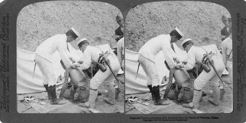 CHINA: BOXER REBELLION. Two Japanese doctors attending to a wounded man after the Battle of Tientsin, China. Stereograph, c1901.  Copyright: xGRANGERx xGRANGERx 0325871
