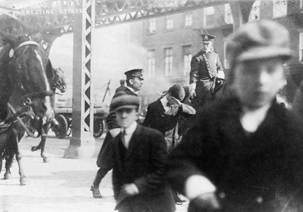 NEW YORK CITY: STRIKE, 1910. Two policemen arresting a striker during an Express strike in New York City. Photograph, 1910.  Copyright: xGRANGERx xGRANGERx 0326529