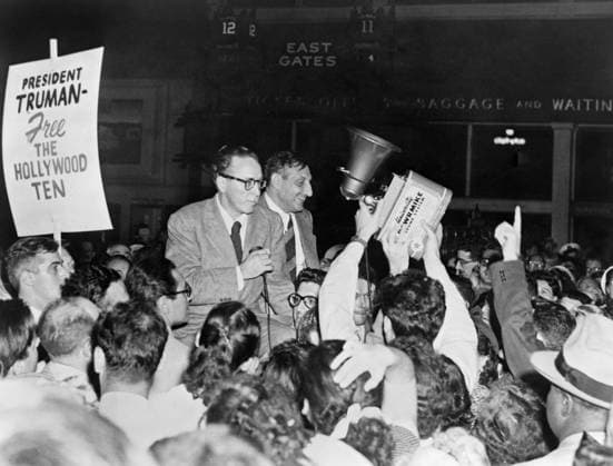 HOLLYWOOD TEN, 1950. Dalton Trumbo and John Howard Lawson, surrounded by supporters, on their way to prison, having been being found in contempt of Congress for refusing to provide information regarding Communism in Hollywood. Photograph, 1950.  Copyright: xGRANGERx xGRANGERx 0526938