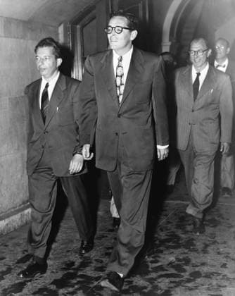 RING LARDNER, JR. (1915-2000). American journalist and screenwriter. Photographed in handcuffs, having been being found in contempt of Congress for refusing to answer questions before the House Un-American Activities Committee, 1950.  Copyright: xGRANGERx xGRANGERx 0526944