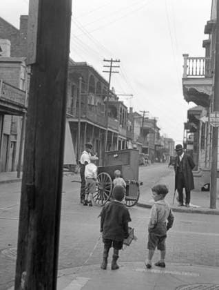 NEW ORLEANS, c1925. Children watching an organ grinder on the street corner in New Orleans, Louisiana. Photograph by Arnold Genthe, c1925.  Copyright: xGRANGERx xGRANGERx 0527357