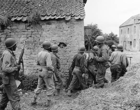 WWII: FRANCE, 1944. American troops preparing to eliminate a German sniper in a village near Vierville-sur-Mer, France. Photograph, 10 June 1944.  Copyright: xGRANGERx xGRANGERx 0528210