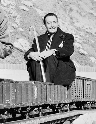SALVADOR DALI (1904-1989). Spanish painter. Dali seated on a coal car of Walt Disney s scale model steam railroad, the Carolwood Pacific Railway, in the backyard of Disney s house in Los Angeles, California. Photograph by Earl Theisen, c1951.  Copyright: xGRANGERx xGRANGERx 0623282