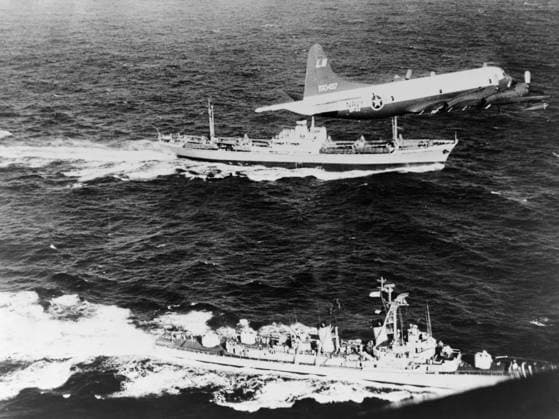 CUBAN MISSILE CRISIS, 1962. The Soviet freighter Anesov, being escorted by a Navy plane and the destroyer USS Barry, while it leaves Cuba, likely loaded with missiles under the canvas cover on deck. Photograph, 1962.  Copyright: xGRANGERx xGRANGERx 0635854