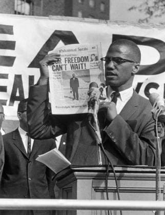 MALCOLM X (1925-1965). Born Malcolm Little. American religious and political leader. Photographed at a Black Muslim Rally in New York City, holding up a newspaper with the headline Our Freedom Can t Wait, 1963.  Copyright: xGRANGERx xGRANGERx 0636035