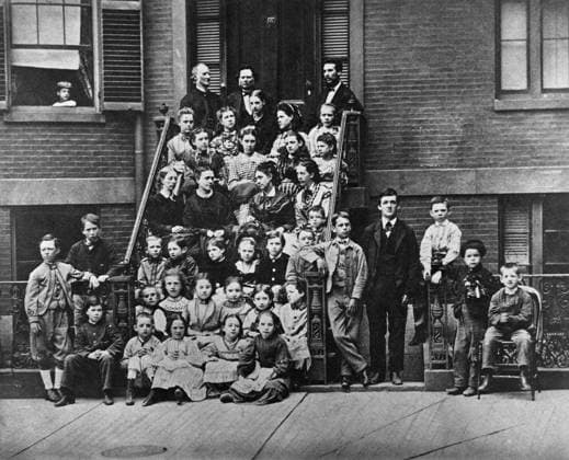 ALEXANDER GRAHAM BELL (1847-1922). American (Scottish-born) teacher and inventor. Bell, with Reverend Dexter King and Dr. Ira Allen, seated on the top step outside Pemberton Square School (Boston School for the Deaf) in Boston, Massachusetts. Below are teachers Annie M. Bond, Sarah Fuller, Ellen L. Barton, and Mary H. True with students. Photograph, 1871.  Copyright: xGRANGERx xGRANGERx 0636534